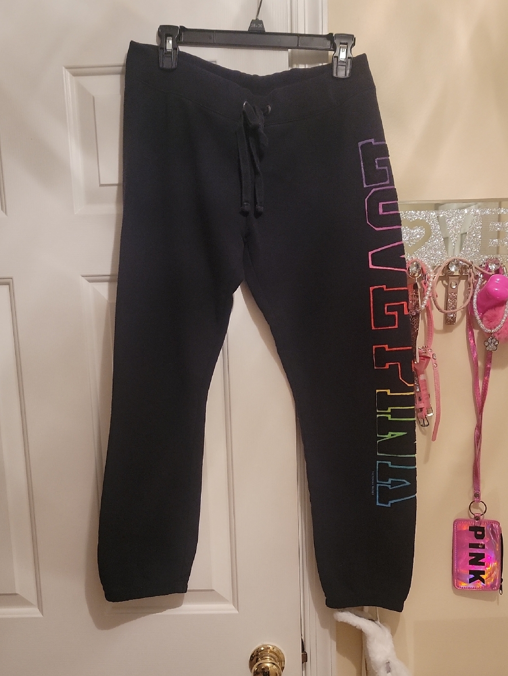 Pink Victorias Secret Black Joggers. Left Leg Has Vibrant Colors Outling Letters